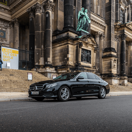 Black chauffeur-service limousine in front of Berlin Cathedral