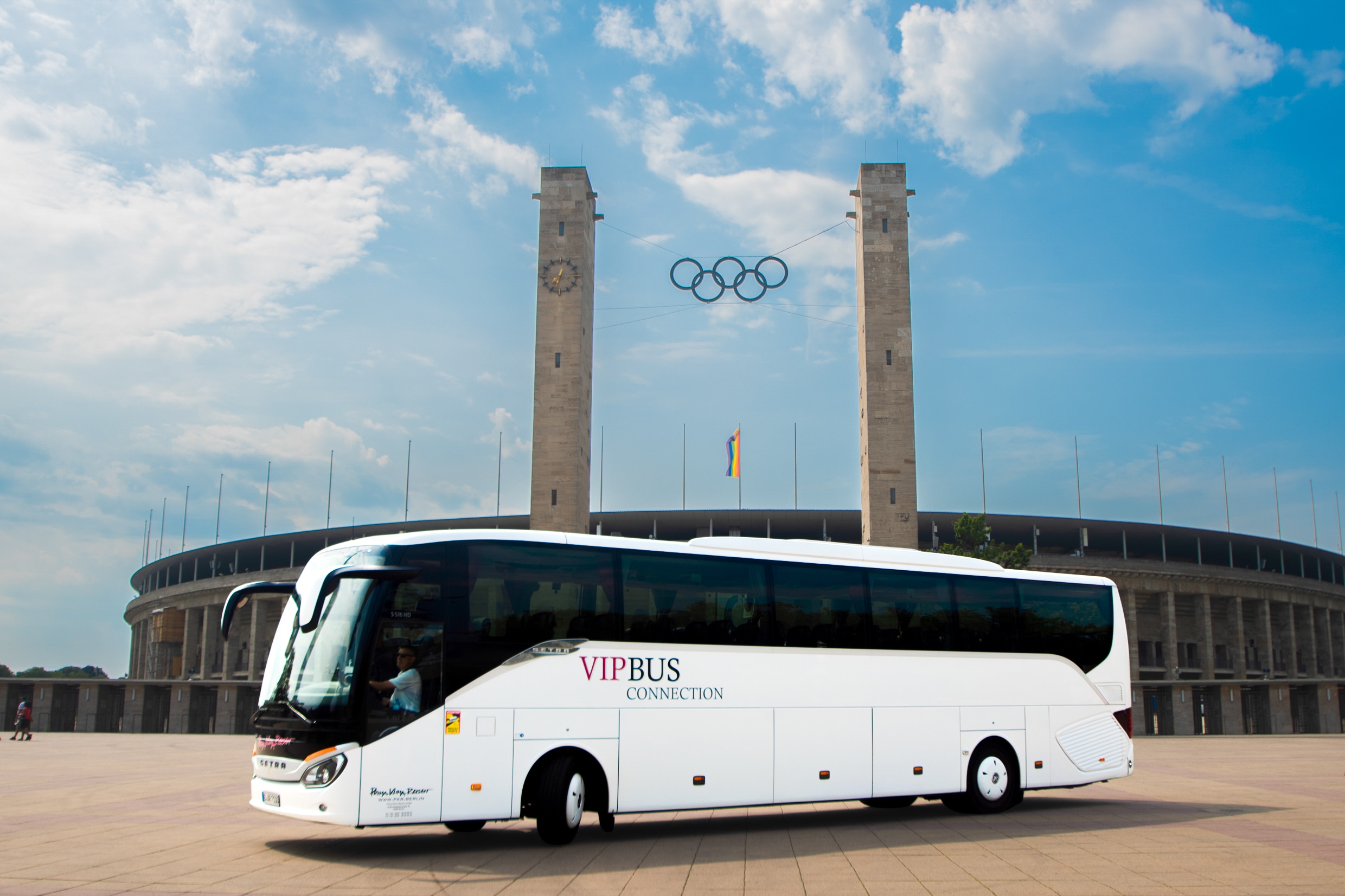 White coach in front of the Olympic Stadium in Berlin