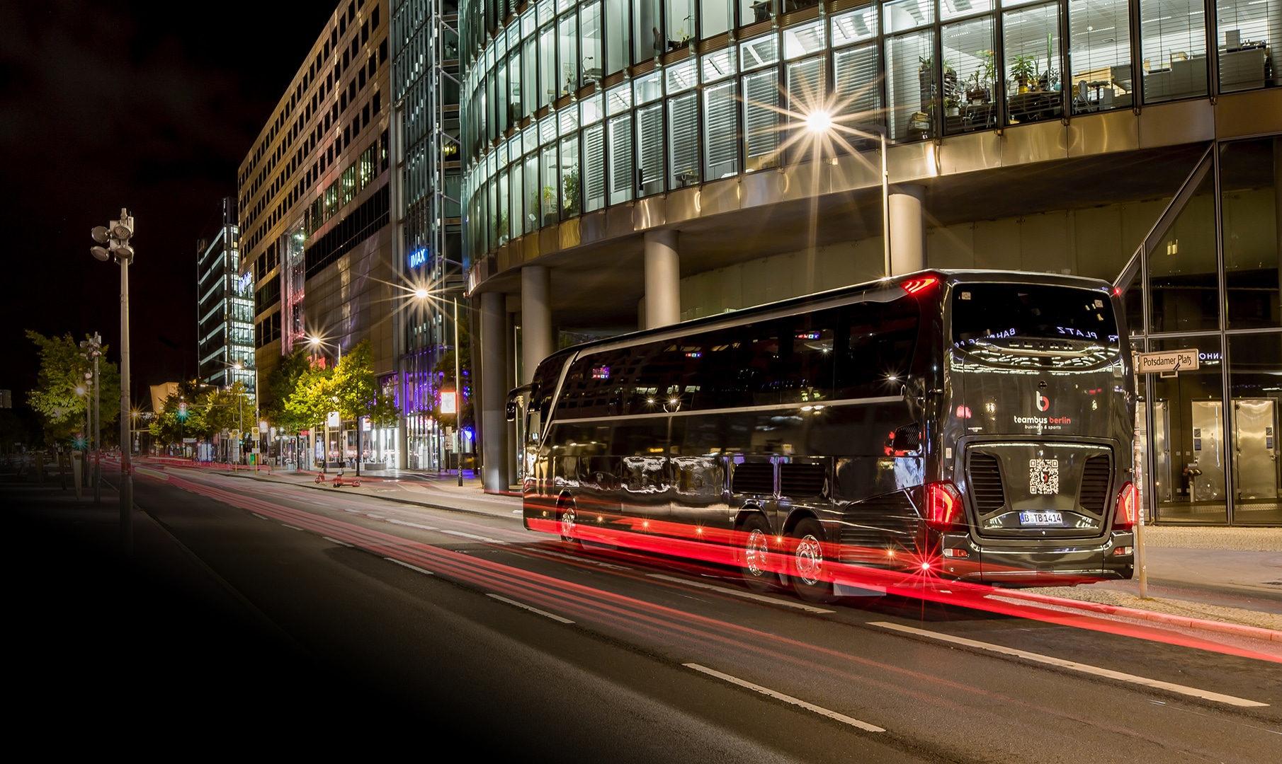 Teambus Berlin by Prima Klima Reisen at night on Potsdamer Platz