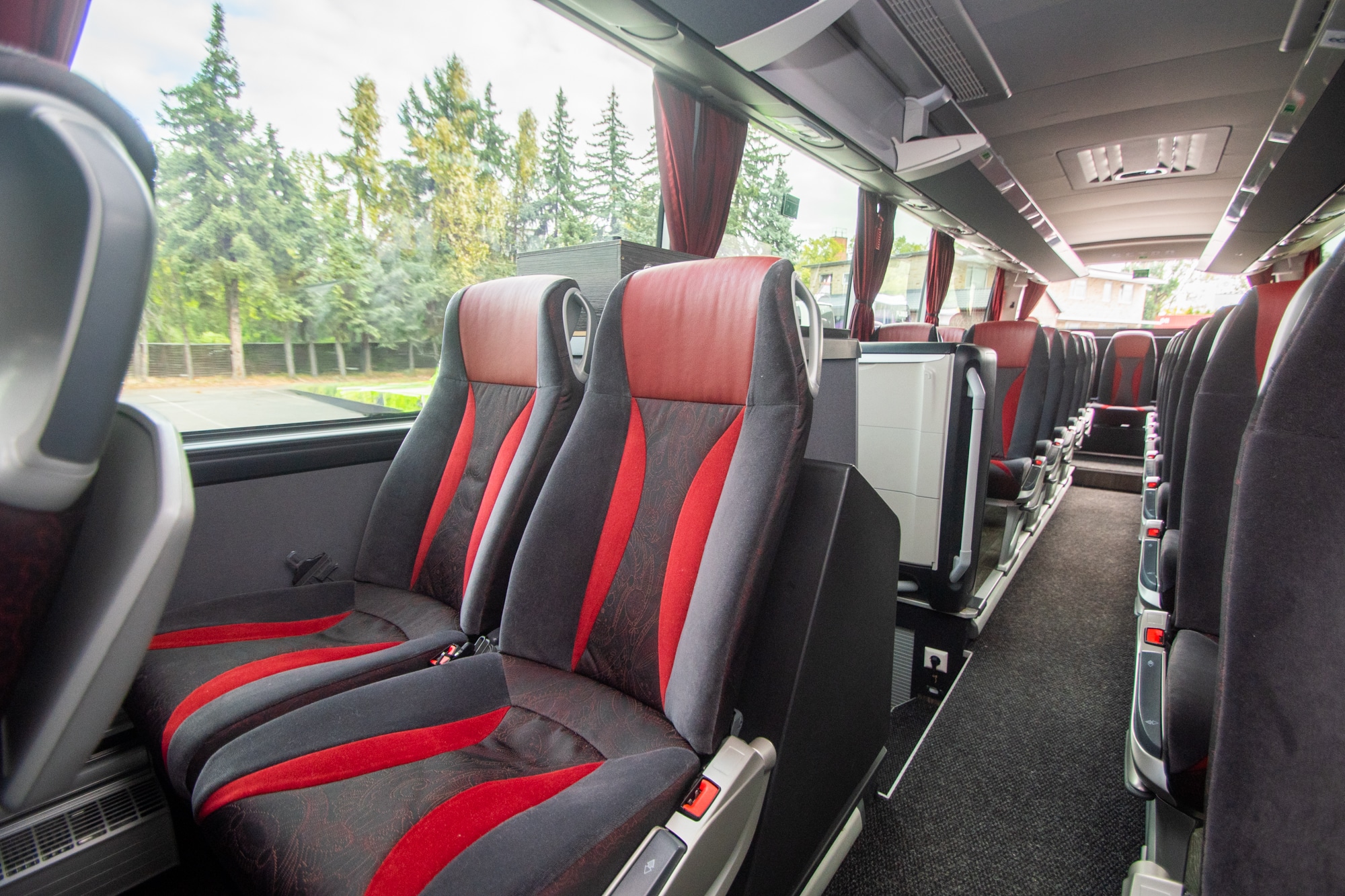 L-Class interior: seats with red and grey upholstery along the centre aisle