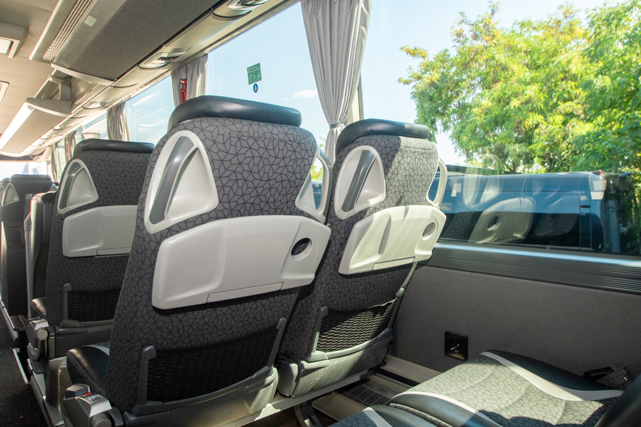 M-Class interior: rows of seats with folding tables