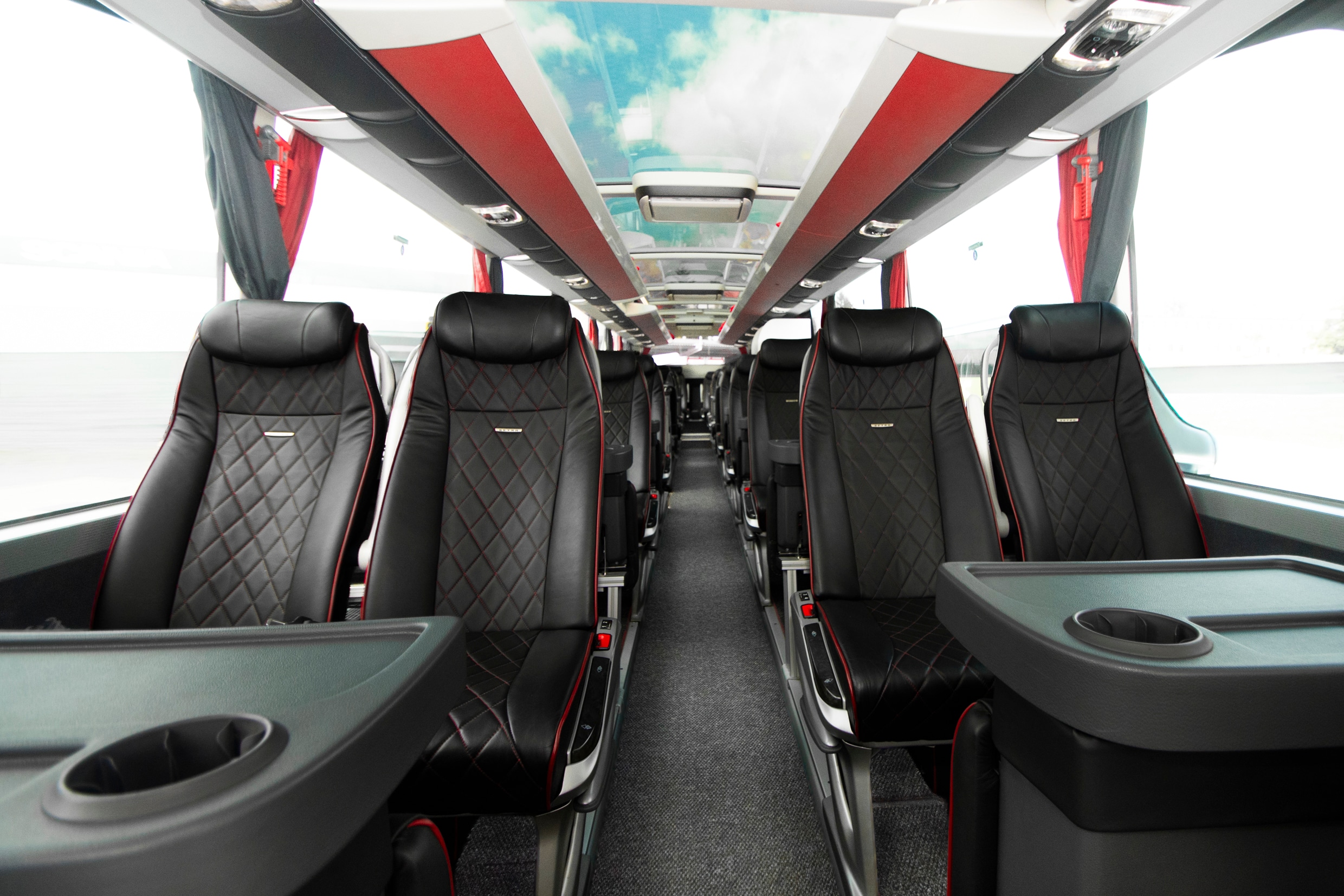 Teambus interior: centre aisle with black leather seats