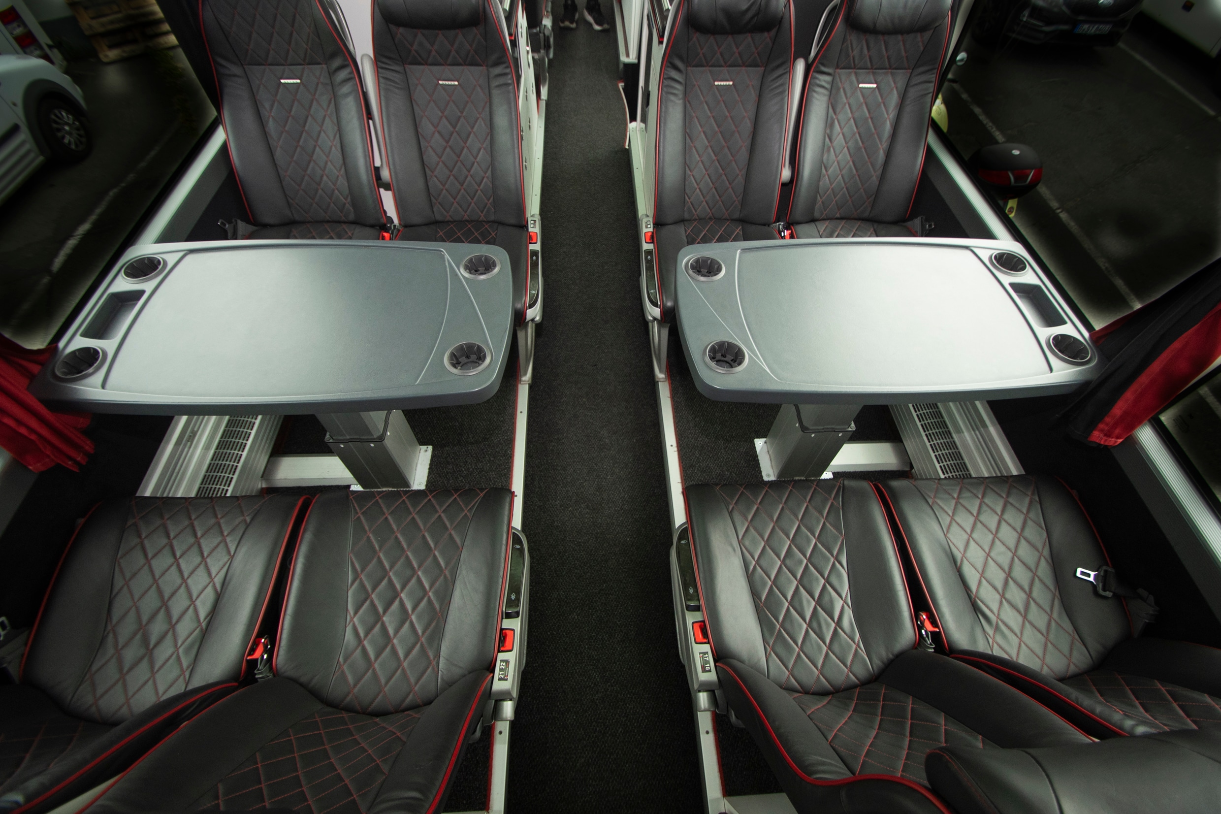 Teambus interior: conference tables with leather seats