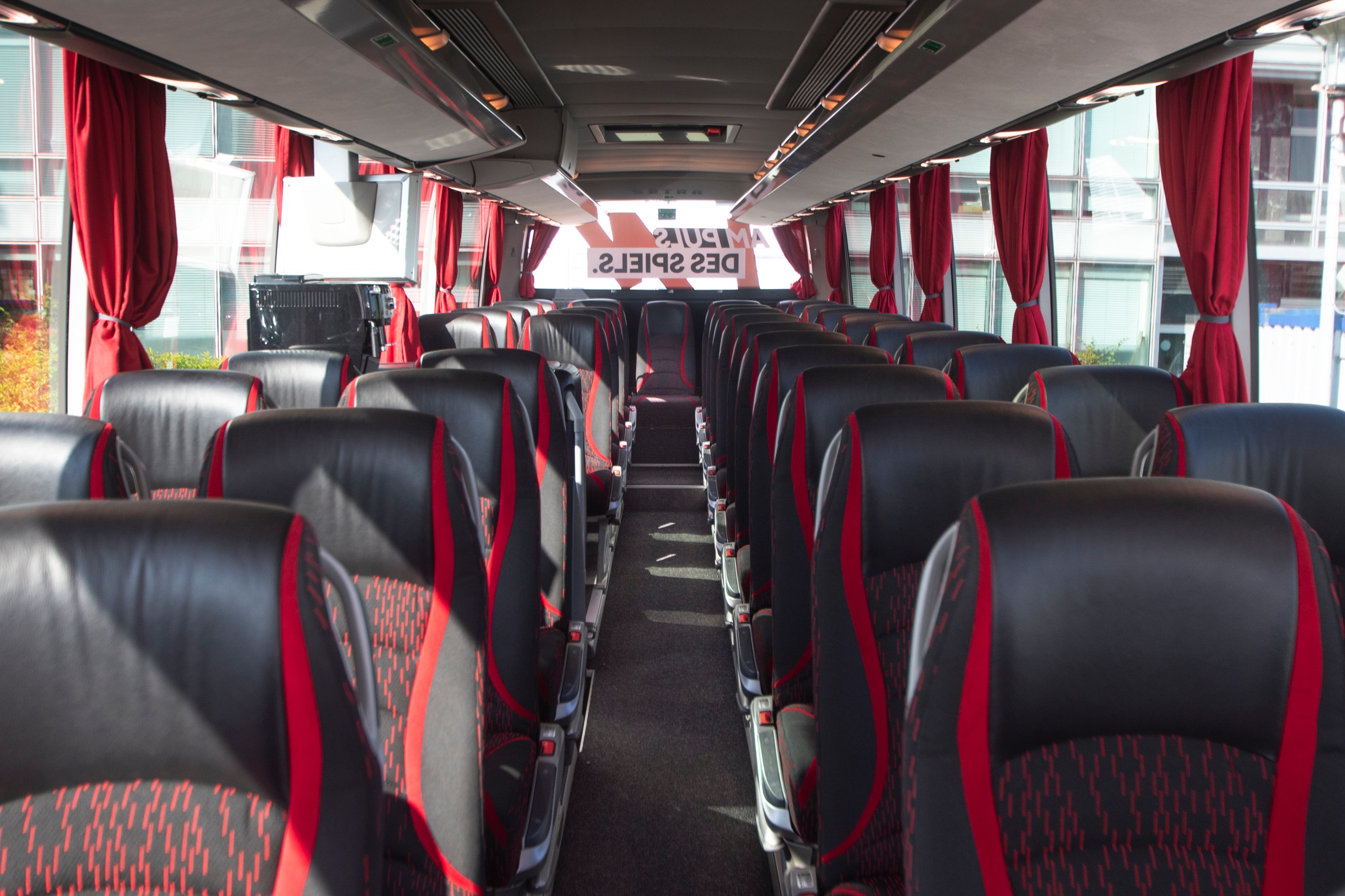 BR Volleys team coach interior: centre aisle with red and black seats