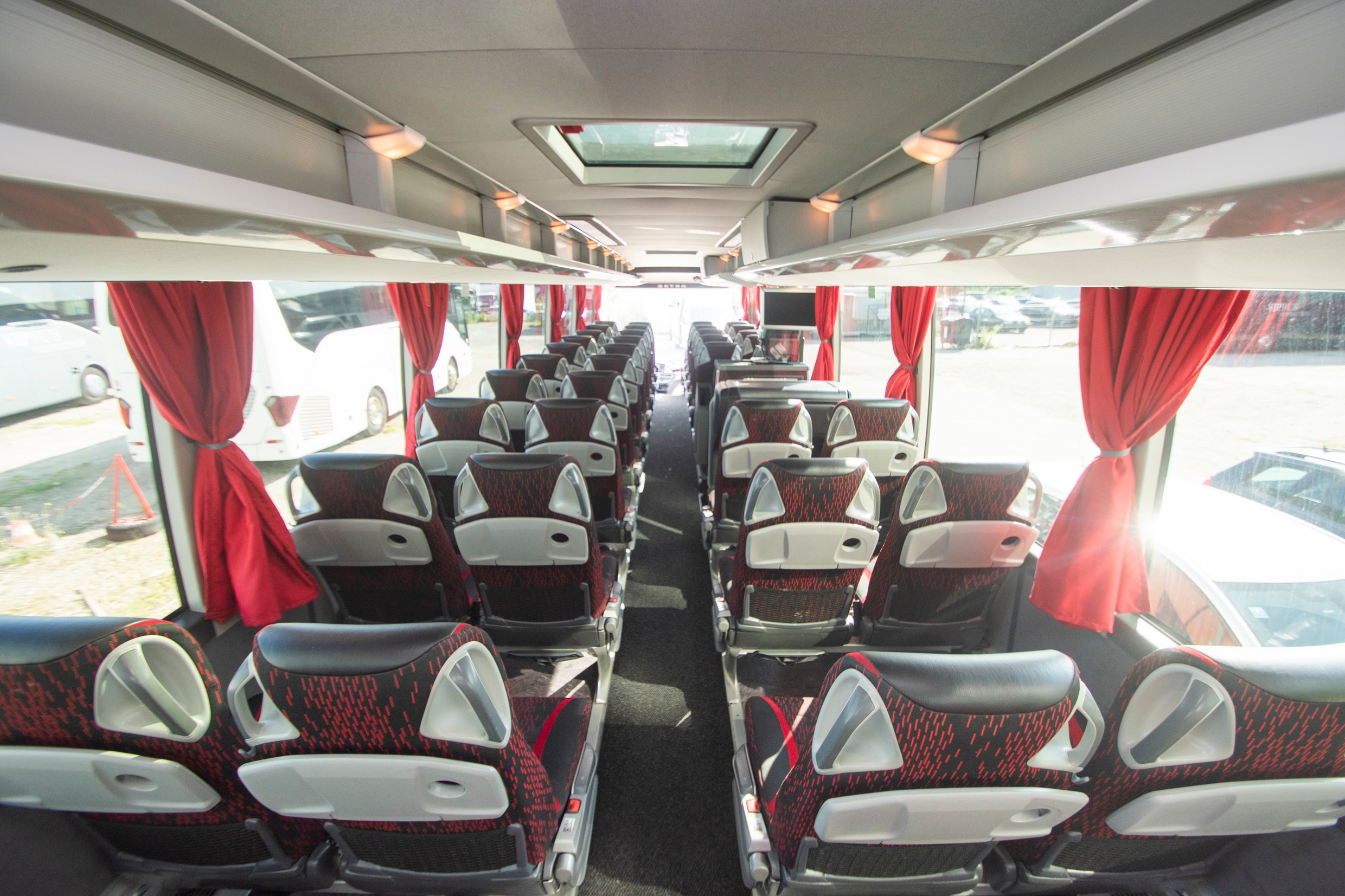 BR Volleys team coach interior: rows of seats with red curtains