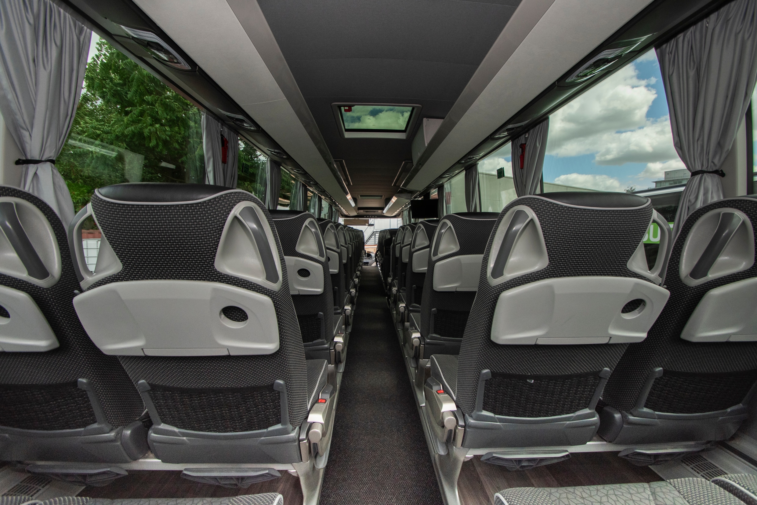 XL-Class interior: rows of seats with folding tables
